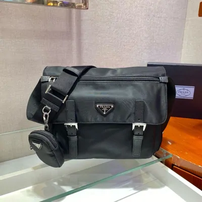 Black nylon messenger bag with a buckled front pouch