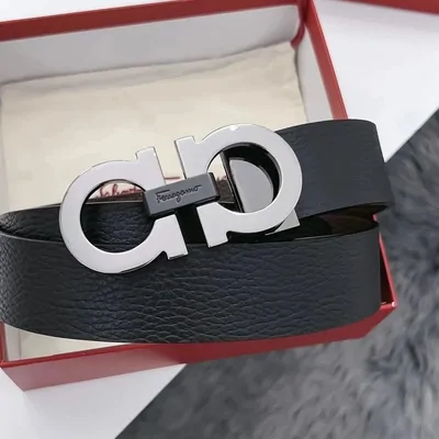 Black pebbled leather belt with a polished double-loop buckle in a red gift box