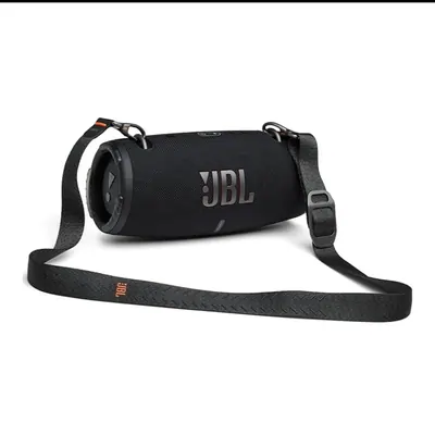 Black cylindrical portable speaker with a shoulder strap