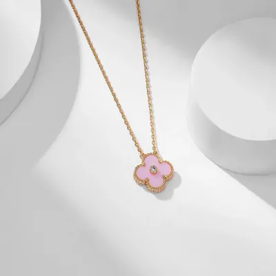 Gold chain necklace with a pink four-leaf clover pendant